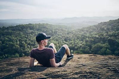 Full length of man sitting on mountain