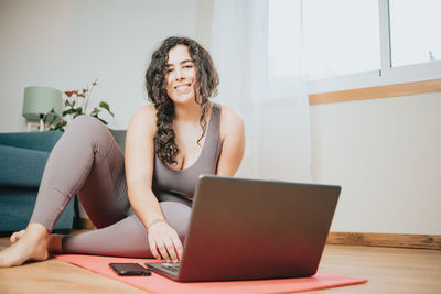 Young woman using laptop at home