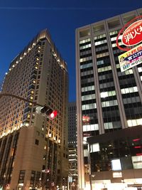 Low angle view of skyscrapers lit up at night