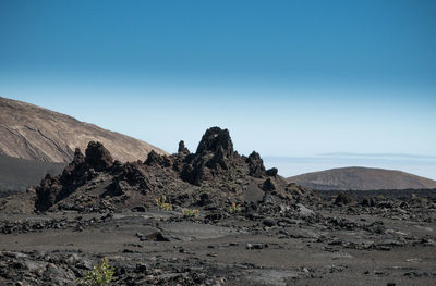 Scenic view of mountains against clear blue sky