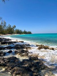 Scenic view of sea against clear blue sky