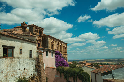 Exterior of old building in town against sky