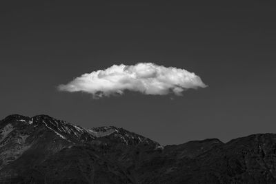 Low angle view of snowcapped mountains against sky