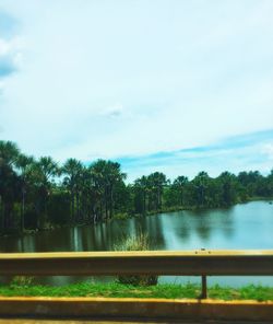 Fountain in lake against sky