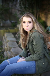 Portrait of beautiful woman sitting outdoors