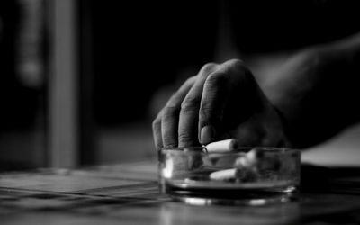 Close-up of hand holding cigarette