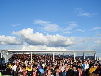 Group of people in traditional clothing against sky