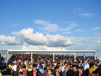 Group of people standing against sky