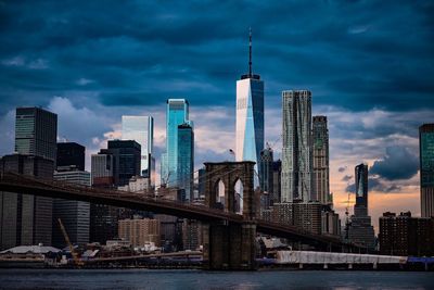 Modern buildings in city against cloudy sky