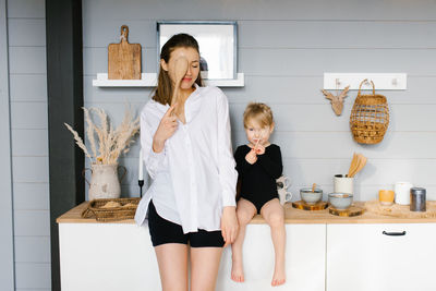 Mother and daughter have fun with wooden spoons