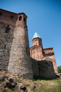 Low angle view of historic building against blue sky