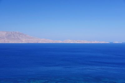 Scenic view of sea against clear blue sky