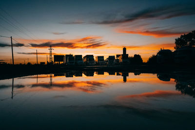 Sunset solhouettes of parked trucks and water reflections