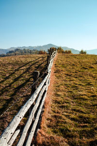 Old wooden fence with barbed wire