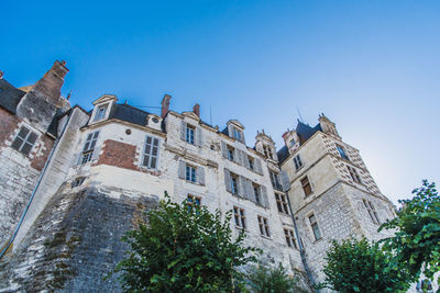 Low angle view of building against clear blue sky