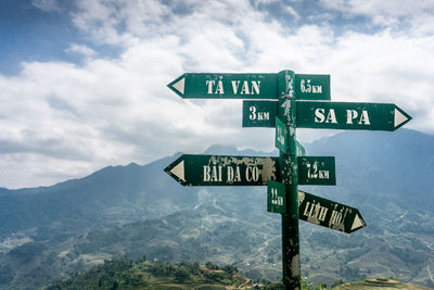 Information sign against sky