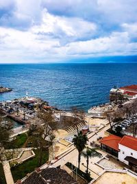 High angle view of buildings by sea against sky