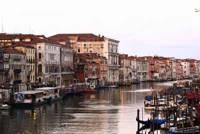 Boats in canal amidst buildings in venice