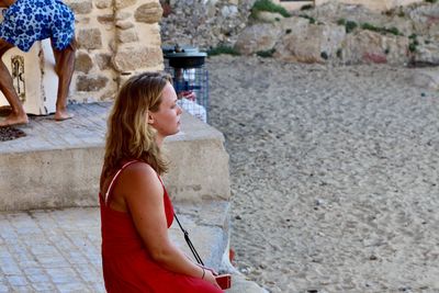 Young woman standing at camera
