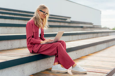 Young woman sitting on staircase