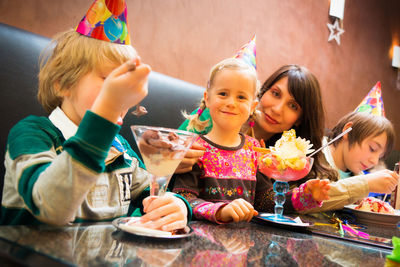 Happy friends sitting on table