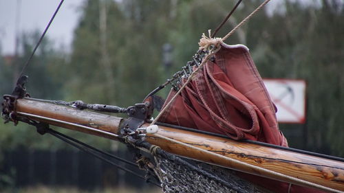 Close-up of rope in the harbour. a red sail.