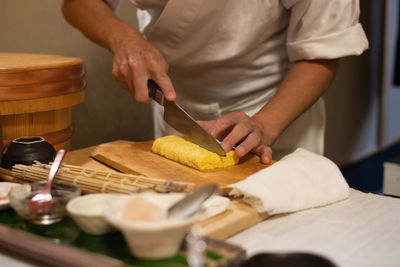 Midsection of man preparing food in kitchen