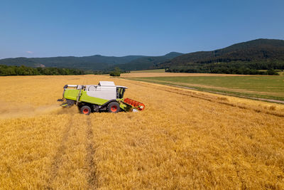 Combine harvester at work during harvest. wheat supply shortage, global food crisis, stockpiling.