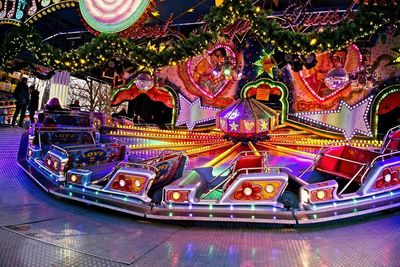Illuminated ferris wheel in amusement park