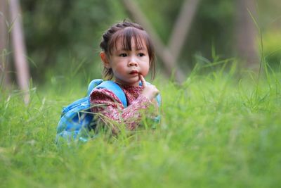 Cute girl looking away on field