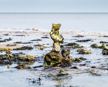 Stack of rocks on shore in sea