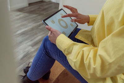 Woman using smart home application on tablet pc