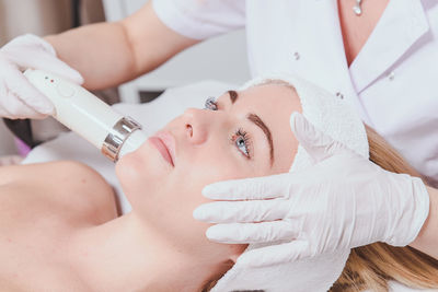 Close-up of woman getting facial beauty treatment