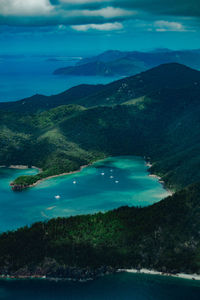 Scenic view of sea and mountains against sky - whitsunday islands, great barrier reef, australia