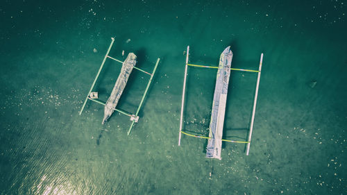 High angle view of deck chairs on lake