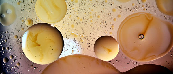 Balls, bubbles and drops in brown, orange and yellow coloring in an abstract surreal arrangement