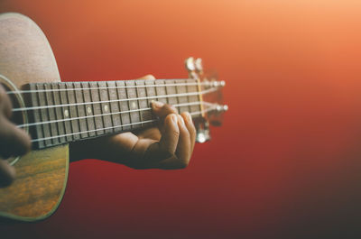 Close-up of man playing guitar