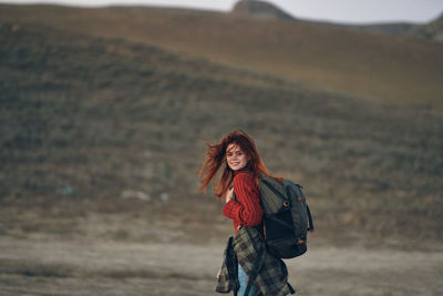 Portrait of young woman standing outdoors