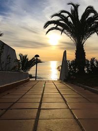 View of swimming pool at beach during sunset