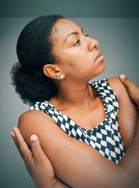 Close-up portrait of young woman against wall