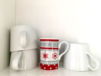 Close-up of coffee cup on table against white background