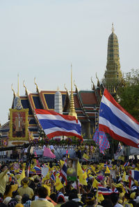 High angle view of people with thai flags at event outside temple
