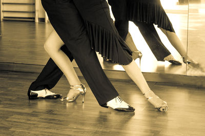 Low section of women on hardwood floor