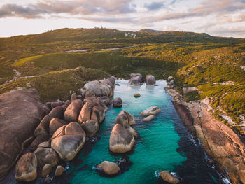 Rocks by sea against sky