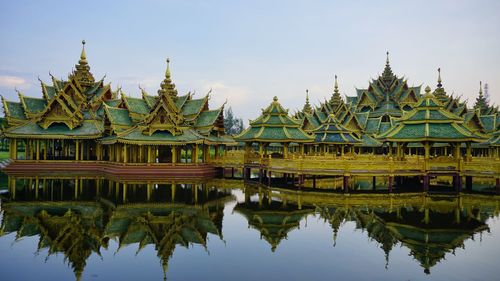 Reflection of temple in lake against sky