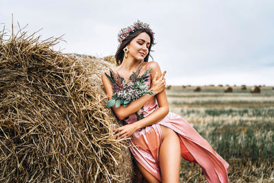 Young woman sitting on field