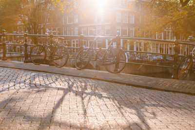 Bicycles parked by railing in city