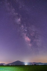 Scenic view of field against sky at night