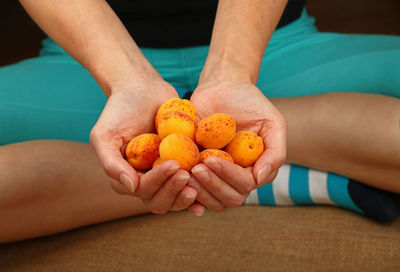 Low section of person holding fruit