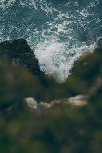 Close-up of sea waves splashing on rocks